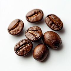 Naklejka premium Dark roasted coffee beans arranged on a white surface for a fresh brewing experience