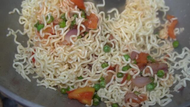 Boil water, add Maggi noodles and seasoning, cook for 2 minutes, stir well, and enjoy a quick, tasty meal.