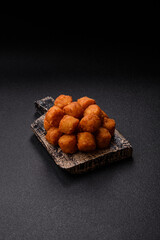 Cheese or potato croquettes, balls fried in breading with salt, spices
