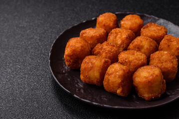 Cheese or potato croquettes, balls fried in breading with salt, spices
