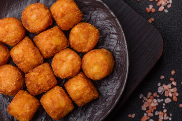 Cheese or potato croquettes, balls fried in breading with salt, spices