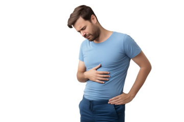 Man in blue shirt holding stomach with pained expression against a black isolated background view on transparent background png