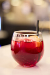Alcoholic cocktail with ice on a bar counter
