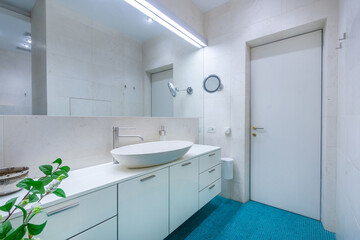 Modern bathroom design with minimalist decor and natural light in a cozy home environment.