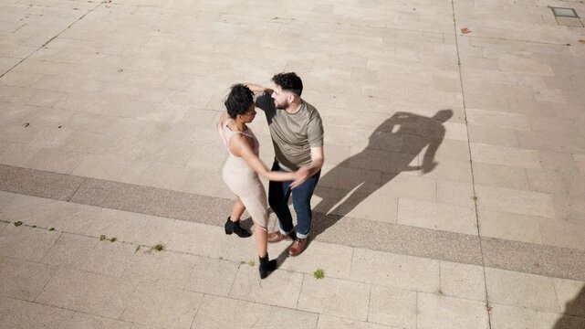 Man and woman dancing cuban salsa in an outdoor urban environment
