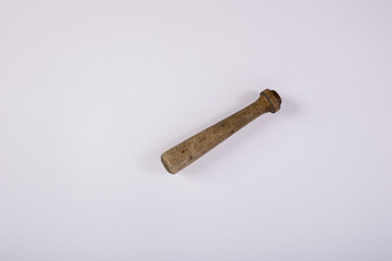 A wooden muddler on a white background