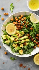 Nutritious Arugula and Avocado Salad with Lemon and Chickpeas in a White Bowl – Healthy and Wholesome Plant-Based Lunch or Snack