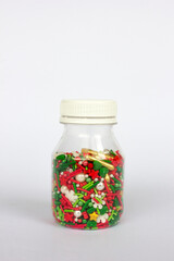 Colorful sprinkles sugar decoration for topping cake and bakery inside a bottle.
