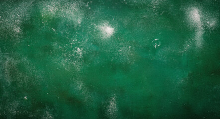 White powder covering a green surface creating an abstract texture