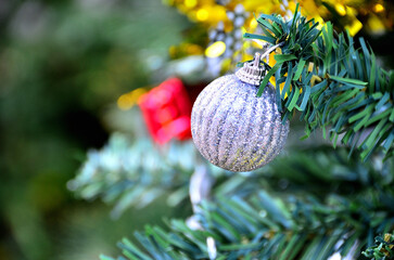 Close-up of Christmas tree decorations with ornaments and pine branches for a festive winter celebration