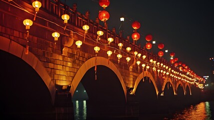 A historic bridge decorated with red lanterns and golden streamers illuminated during a Chinese cultural event