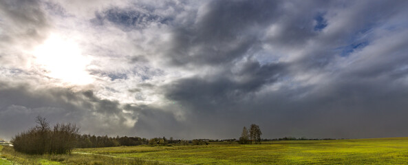 Cloudy sky with a sun in the background