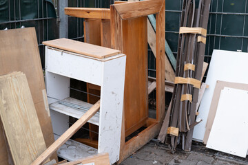 Discarded household items in messy pile on street, broken furniture, renovation, minimalism, and sustainability, collecting and recycling bulky waste to reduce environmental pollution