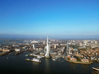 Obraz premium Aerial view of the sail-shaped Spinnaker Tower in Portsmouth Harbor in the south of England on the Channel coast – Gunwharf Quays modern shopping mall in a residential waterfront area