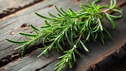Obraz premium Fresh rosemary on a wooden surface. A cluster of fragrant green rosemary. Herbs and spices, an ingredient for fish and meat. Culinary idea.