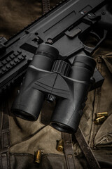 Obraz premium Tactical Gear with Binoculars and Rifle for Outdoor Adventure