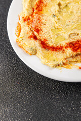 Hummus chickpea dip spices tasty appetizer vegetable dish fresh delicious gourmet vegetarian and vegan food background on the table rustic food top view copy space keto and paleo diet