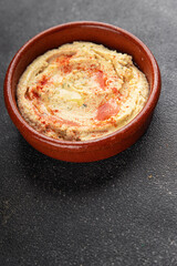 Hummus chickpea dip spices tasty appetizer vegetable dish fresh delicious gourmet vegetarian and vegan food background on the table rustic food top view copy space keto and paleo diet