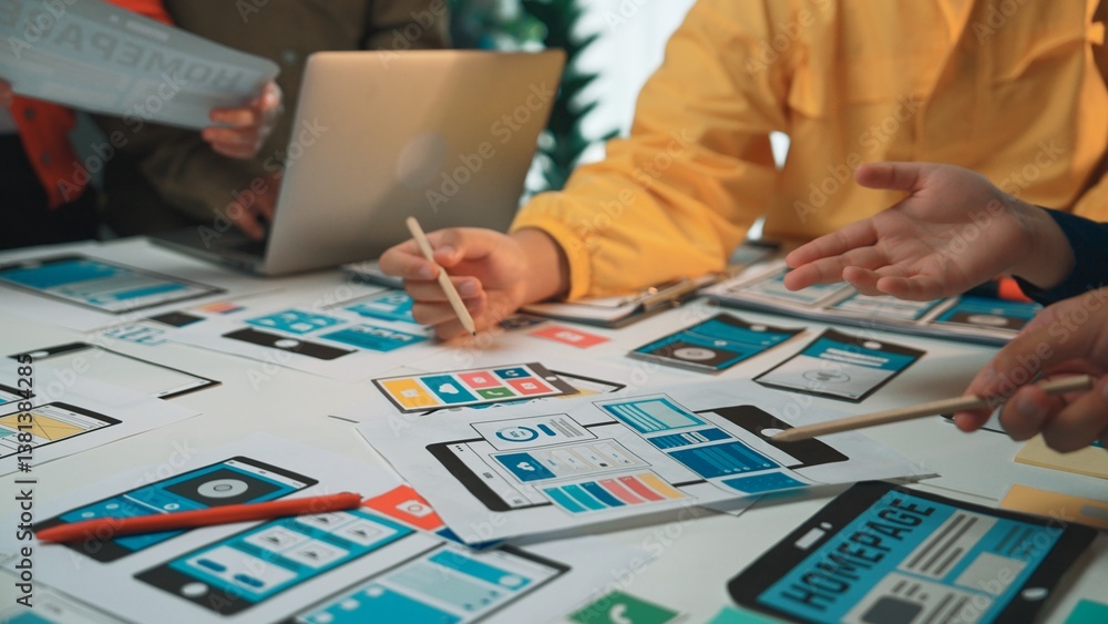 Poster a diverse team collaborates on a digital project surrounded by wireframe mockups for web and mobile 