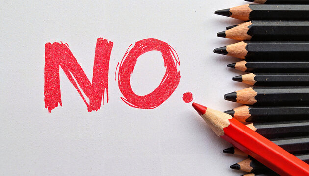 Red pencil emphasizes 'NO' among black pencils, empowerment concept