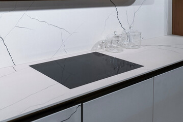 Induction hob on marble top with glass pots