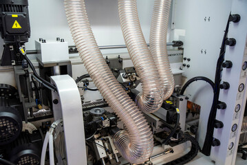 Industrial processing machine with flexible exhaust hoses