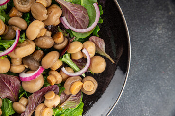 Mushroom salad green lettuce canned champignon mushrooms fresh gourmet food background on the table rustic food top view copy space