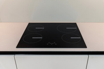 Modern black induction hob with four zones