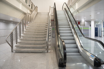 Modern escalators in an international airport terminal, with sleek architecture and natural...