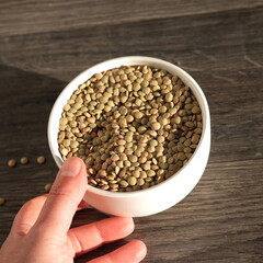 hand holding bowl with lentils