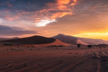 Red sand dunes and sunset sky in Namib desert at Namib-Naukluft National Park of Namibia, Africa. Landscape photography