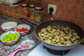 Close-up of fried eggplant with other ingredients in a local kitchen