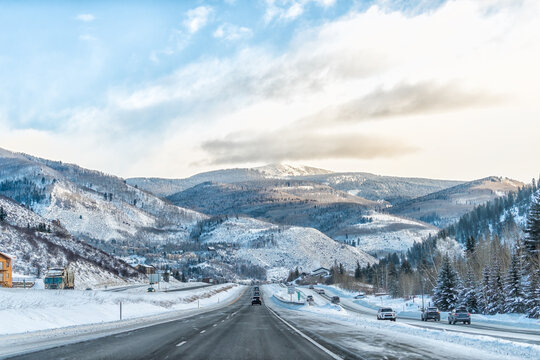 Vail, Colorado snow capped rocky mountains in winter highway road driving pov with beautiful hills ski resort slopes and trees
