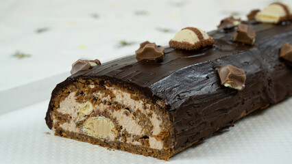 Delicious chocolate cake with juicy filling cream and crushed biscuits