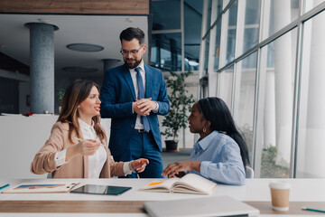Businesspeople discussing strategy during office meeting
