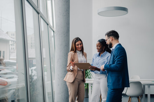 Business people discussing work using tablet in office