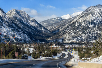 Frisco, Colorado snow capped rocky mountains peaks in winter weather and houses buildings on street road to downtown