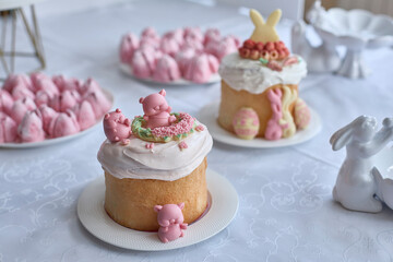 Blossoming spring joy, a delicate spread of frosted cakes and playful marshmallow piglets evokes Easter's sweet promise and familial togetherness, ideal for greetings or culinary inspiration.