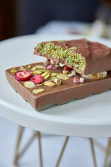 Dubai chocolate. Delicious fractured chocolate bar, speckled with freeze- dried raspberries and refreshing pistachio crumble, evokes indulgence, sweetness, and a vibrant burst of flavor, perfect for p