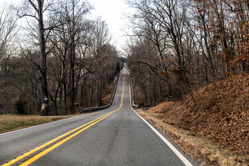 Scottsville Virginia country paved road, countryside rural town or village with forest woods in...