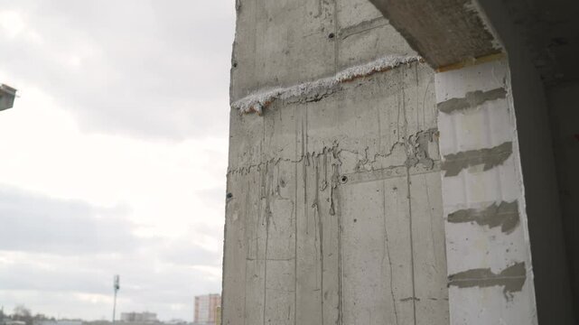 Structural concrete wall revealing construction defects and potential integrity issues during urban development project