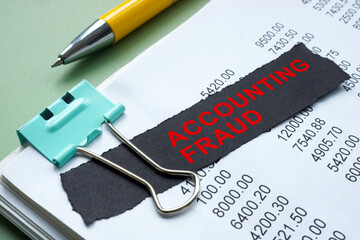 Stack of papers marked accounting fraud. Financial crime concept