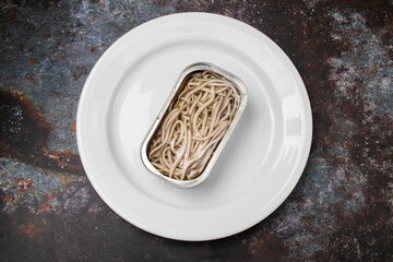 Traditional Spanish food. Gulas with oil in iron box.