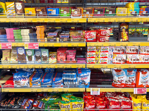 Assorted candy and chocolate display in grocery store aisle
