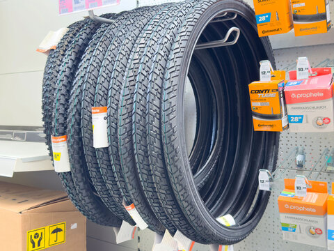 Bicycle tires display in store with tubes and labels on shelf