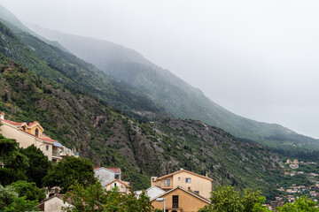 Kotor Skurda canyon cliff mountains by old fort fortress trail hike in rain and cityscape skyline of old town Montenegro coastal city in summer