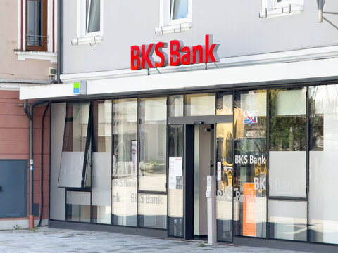 Exterior view of bks bank building with red signage and glass windows