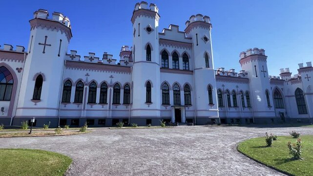 Belarus, Puslovsky Palace, September 5, 2024: Kossovsky Autumn Castle. An old historical castle in Kosovki in sunny autumn weather. An architectural monument in the style of English Neo-Gothic. 4K