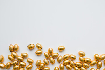 Golden chocolate eggs on white background