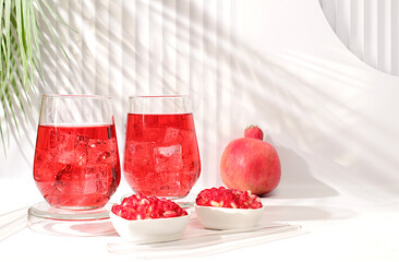 Fruit juice and ingredients, summer drink or tonic with pomegranate and ice on bright table, detox diet and weight loss concept, healthy and natural food, source of vitamin C, selective focus